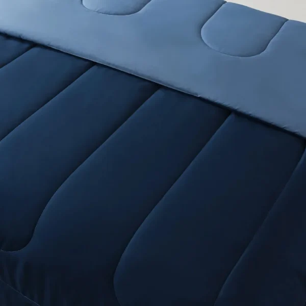 Reversible Microfiber Comforter Navy Twin Twin XL Adult Unisex 1 Experience versatility with our Reversible Microfiber Comforter in Navy. Perfect for adults of any gender, this twin/twin XL comforter offers both style and functionality. Elevate your sleep space effortlessly.